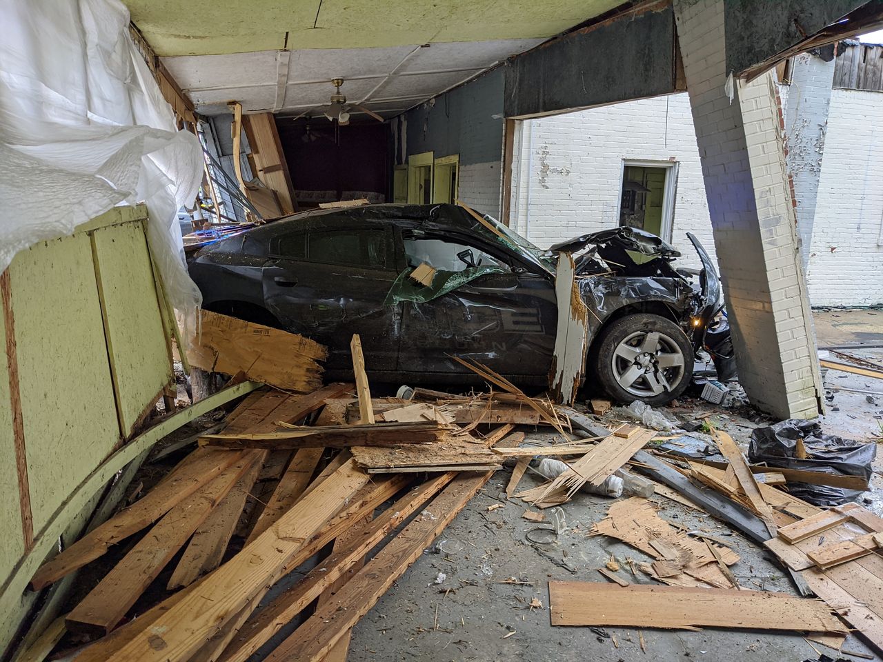 Officer Injured After Crashing Into Vehicle, Then Building